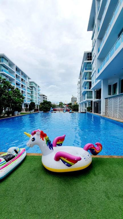 a swimming pool with two inflatables on the grass at My Resort Huahin by Vas in Hua Hin