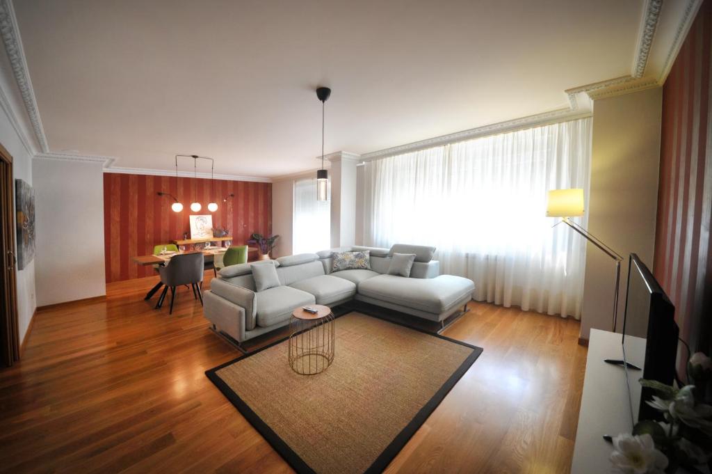 a living room with a couch and a table at Apartamento Rego da Balsa in Carballo