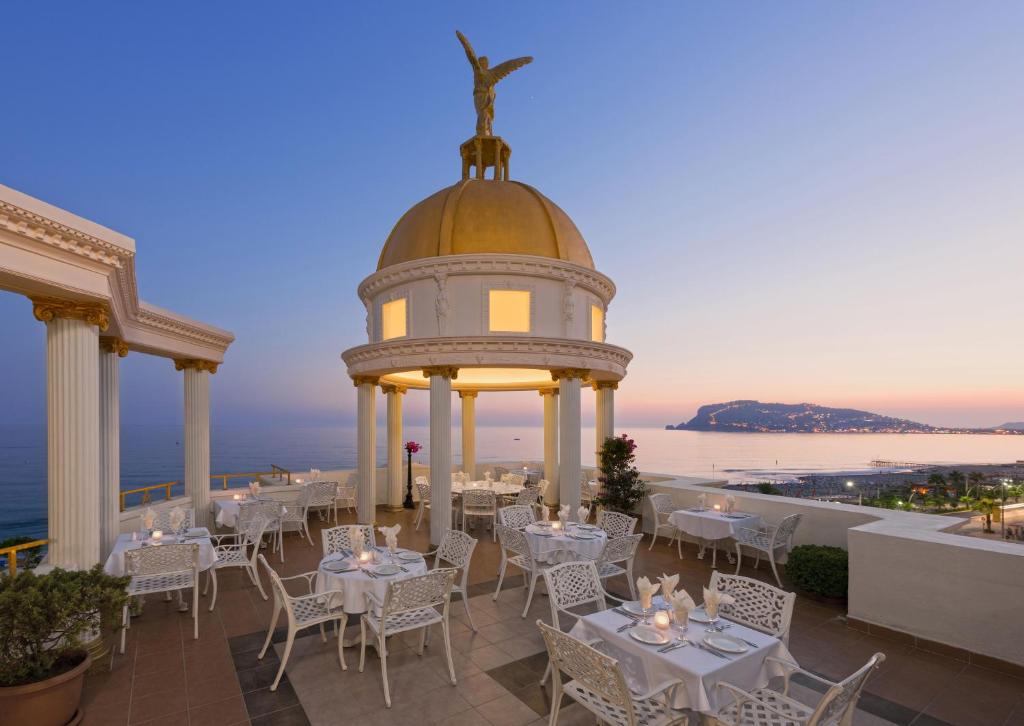 a restaurant with a gazebo with tables and chairs at Museum Hotel Antique Roman Palace - Adults Only Ultra All Inclusive in Alanya
