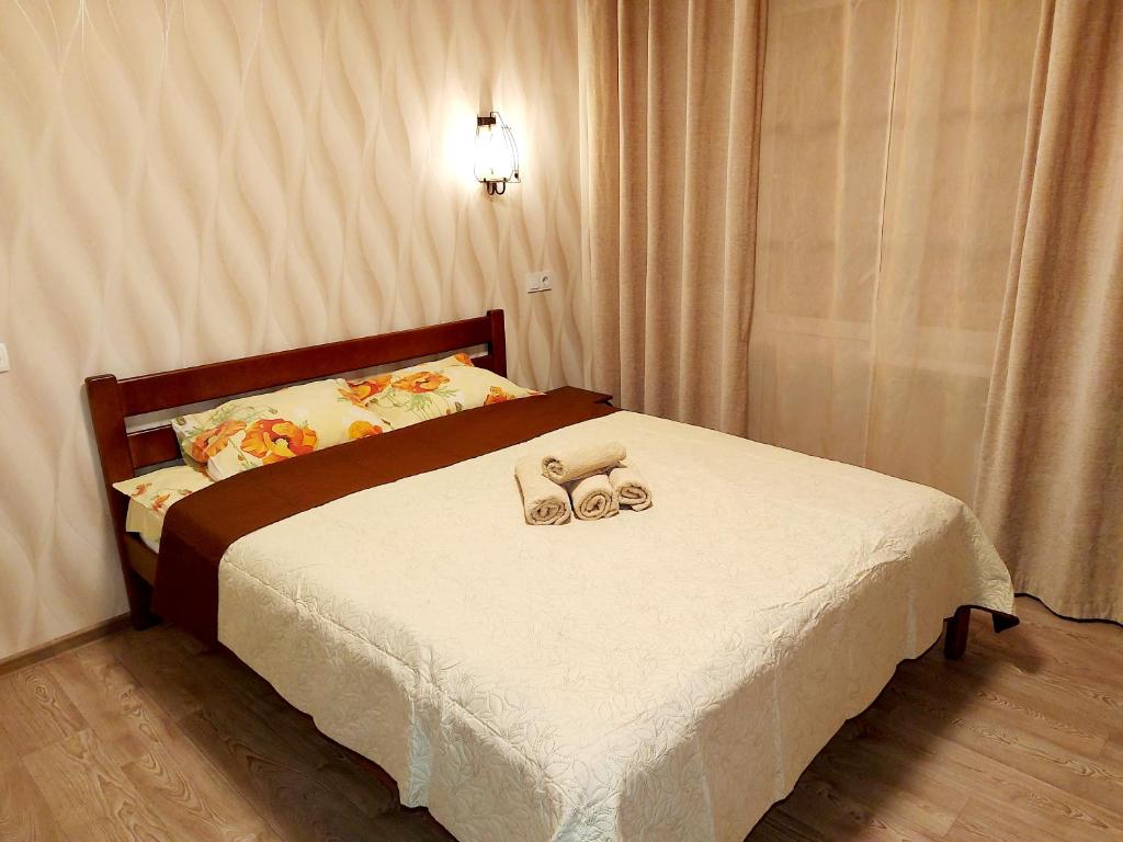 a bedroom with a bed with two shoes on it at 1к квартира Оболонь- м.Минская и Героев Днепра in Kyiv