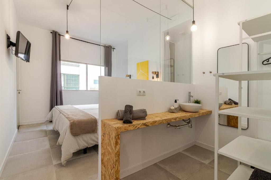 Postel nebo postele na pokoji v ubytování Flatguest Paez Suites