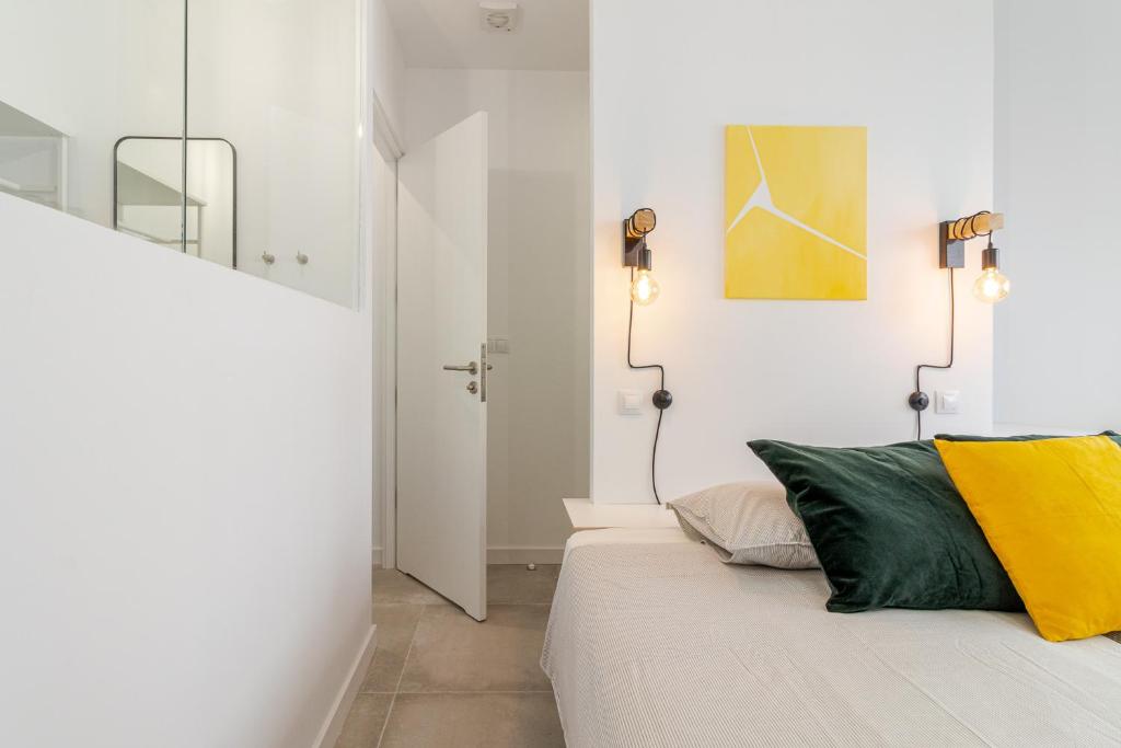 Postel nebo postele na pokoji v ubytování Flatguest Paez Suites
