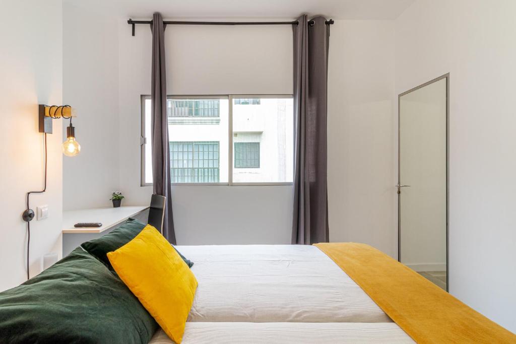 Postel nebo postele na pokoji v ubytování Flatguest Paez Suites