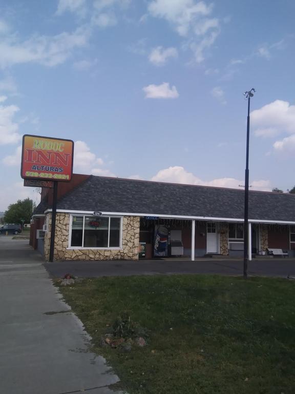 a building with a sign in front of it at Modoc Inn in Alturas