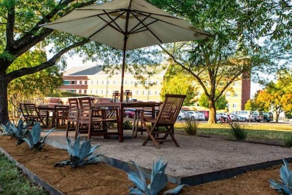 a table and chairs under an umbrella in a park at 1700 South 2nd in Waco