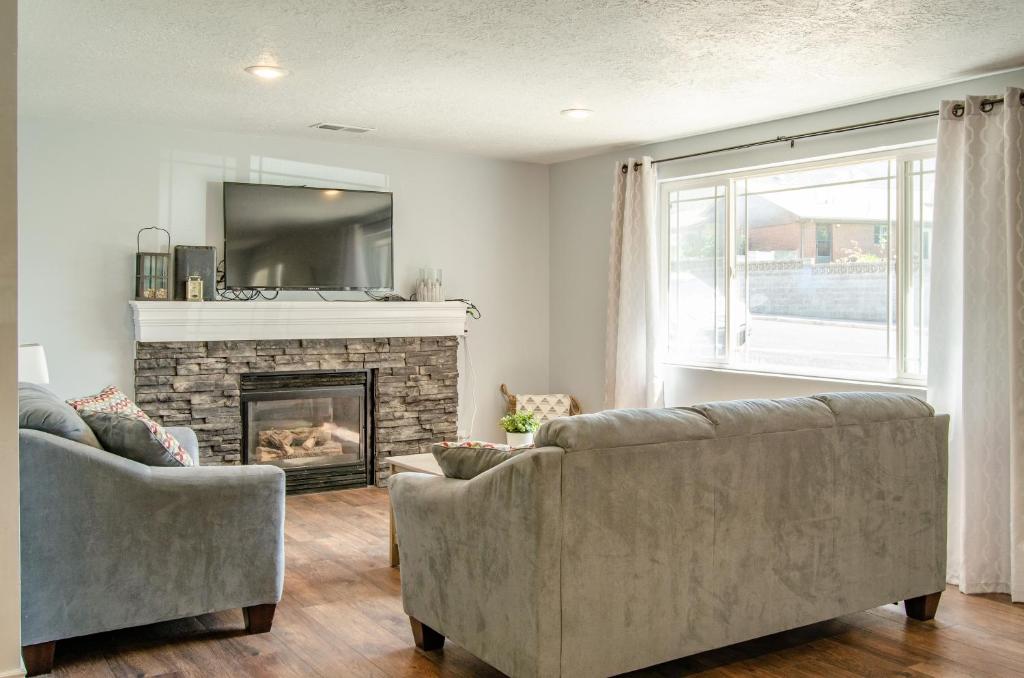 a living room with two couches and a fireplace at Never Stop Exploring- 3 bedroom 2 bath home of duplex, close to Zion, Bryce, and Brianhead in Cedar City