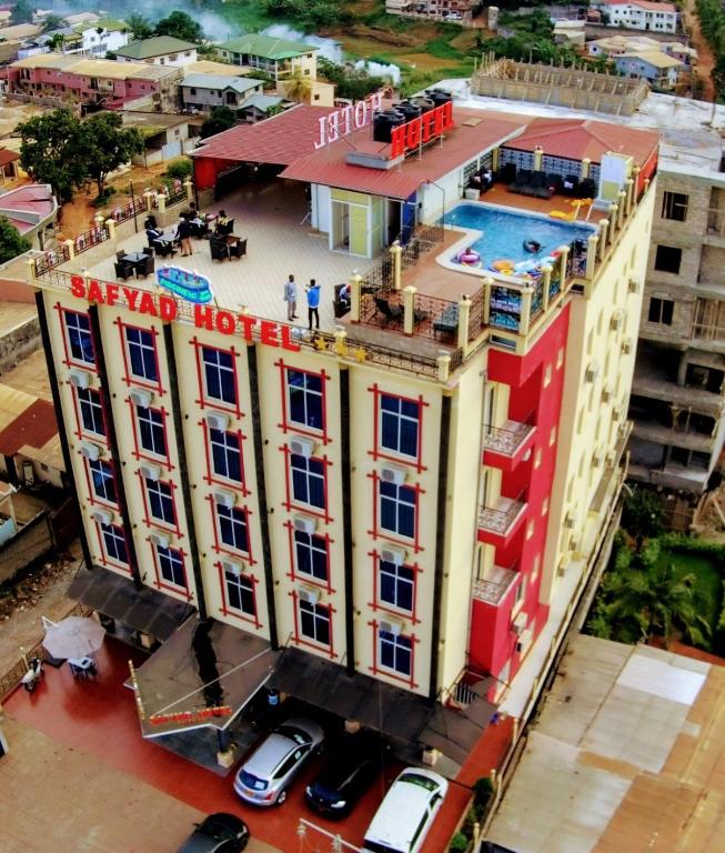 an overhead view of a hotel with cars parked in front of it at Safyad Hotel in Yaoundé