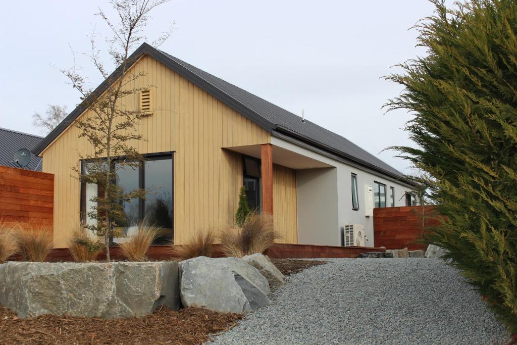 a house with a large window on the side of it at Fivestone Suite in Lake Tekapo