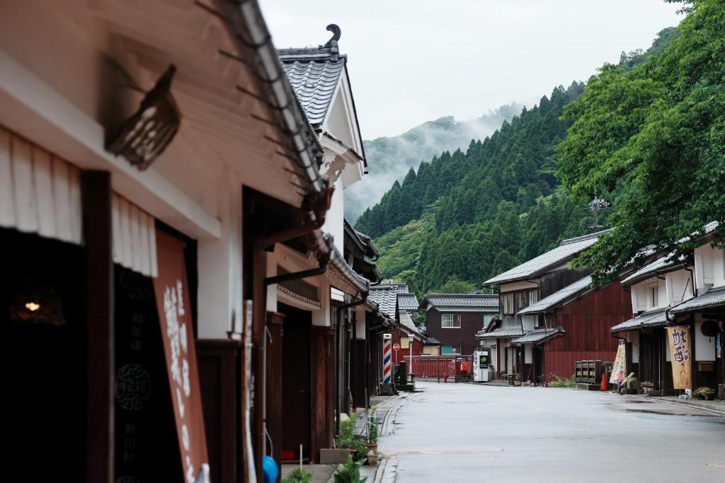 an empty street in a town with a mountain at 八百熊川 Yao-Kumagawa in Kumagawa