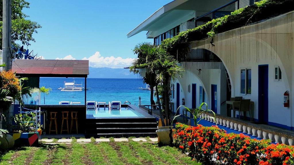 a house with a view of the ocean at Pescadores Suites Moalboal in Moalboal