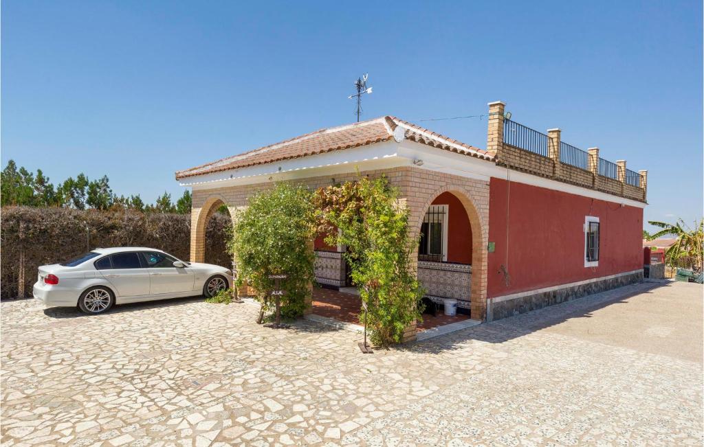 a white car parked in front of a house at 3 Bedroom Beautiful Home In Olivares in Olivares