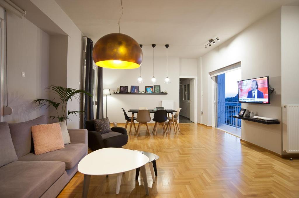 a living room with a couch and a table at Acropolis View Penthouse N in Athens