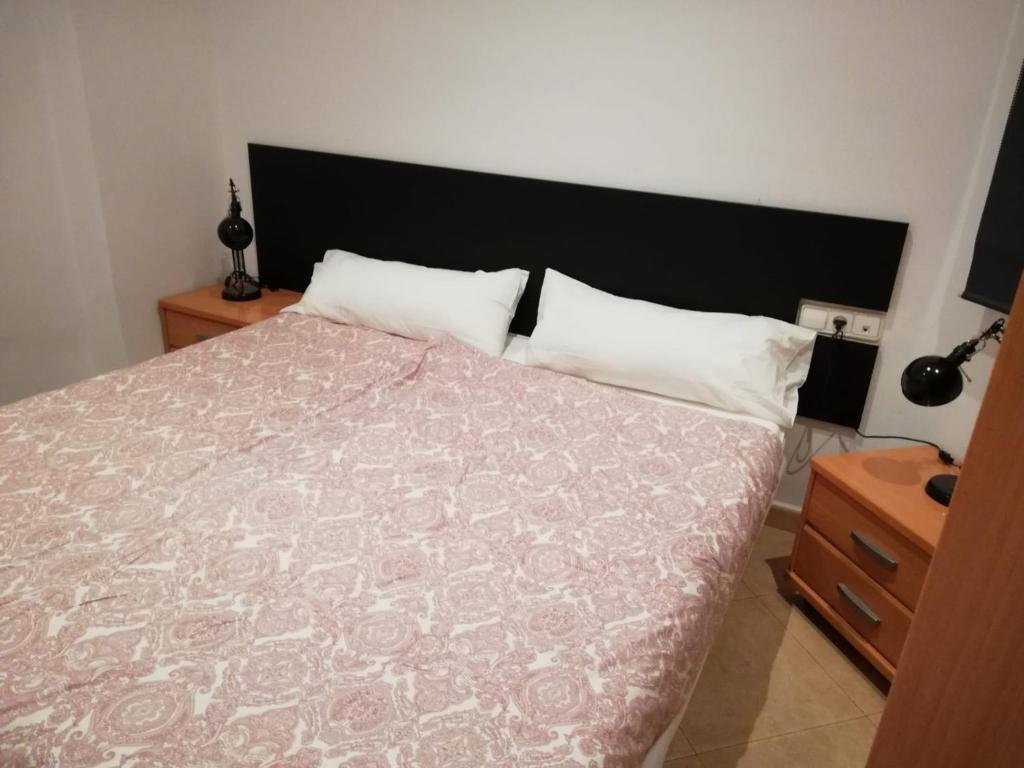 a bedroom with a large bed with a black headboard at Apartment Sabadell 2 in Sabadell