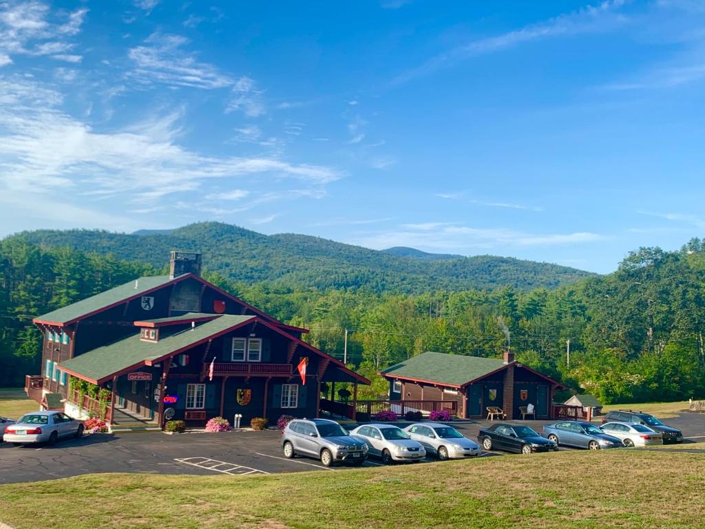 a group of cars parked in front of a building at Swiss Chalets Village Inn in North Conway