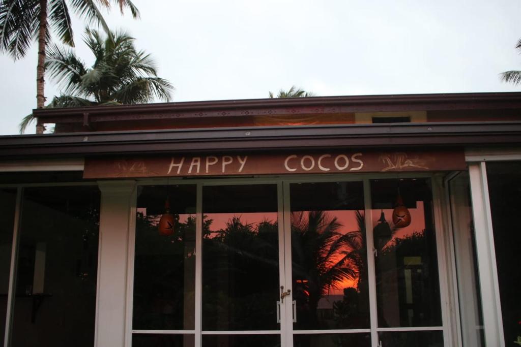 a happy cocos sign on the front of a restaurant at Happy Cocos Beach House in Waskaduwa