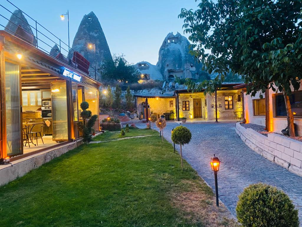 a courtyard of a building with lights on the grass at YASTIK HOUSES - Cappadocia in Goreme