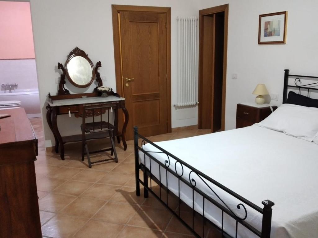 Postel nebo postele na pokoji v ubytování B&B L'Oliveto