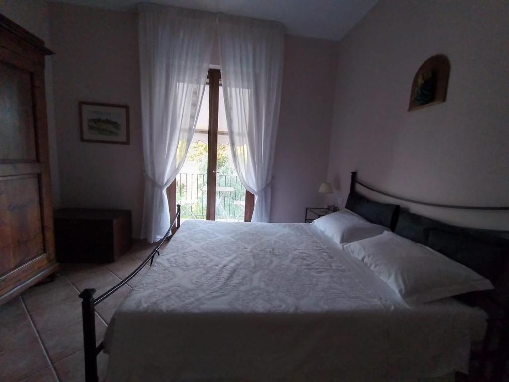 Postel nebo postele na pokoji v ubytování B&B L'Oliveto