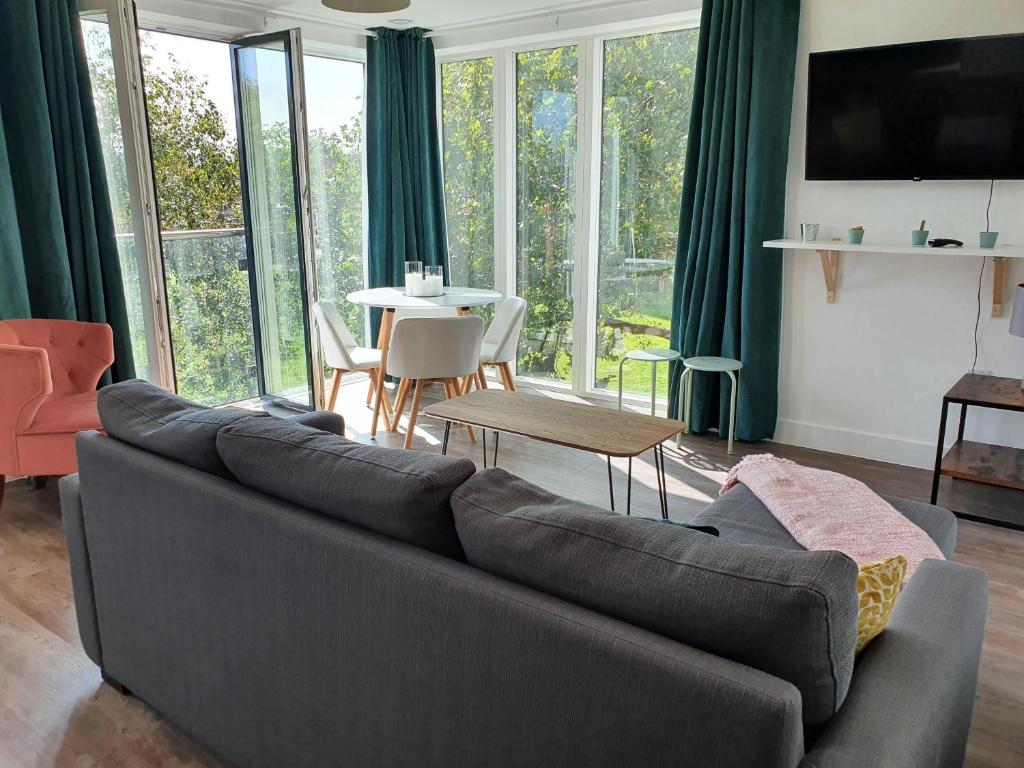 a living room with a couch and a table at Cooperage Court by Cliftonvalley Apartments in Bristol