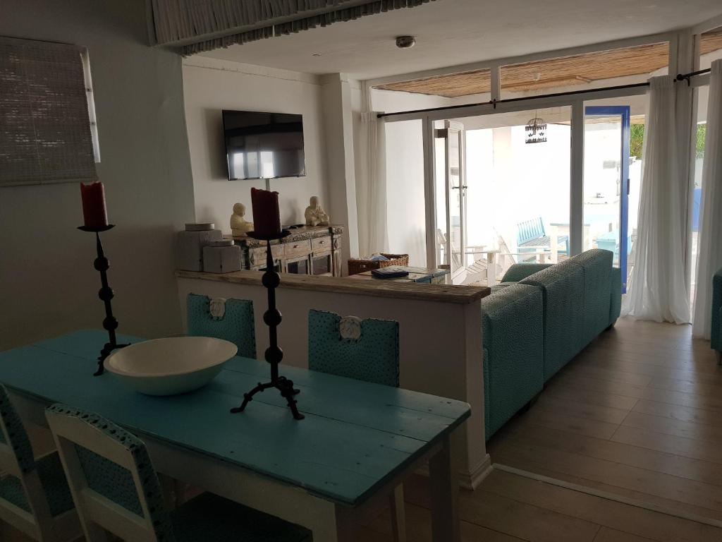 a living room with a table and a couch at Mosselbank Beach Retreat 2A in Paternoster