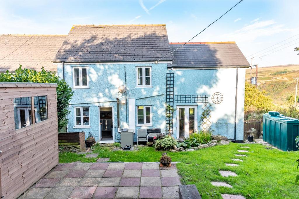 a blue and white house with a yard at Finest Retreats - Brecon View Cottage in Clydach