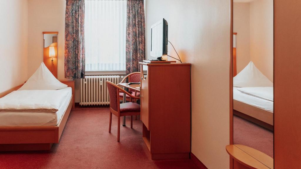 Postel nebo postele na pokoji v ubytování Avantgarde Hotel