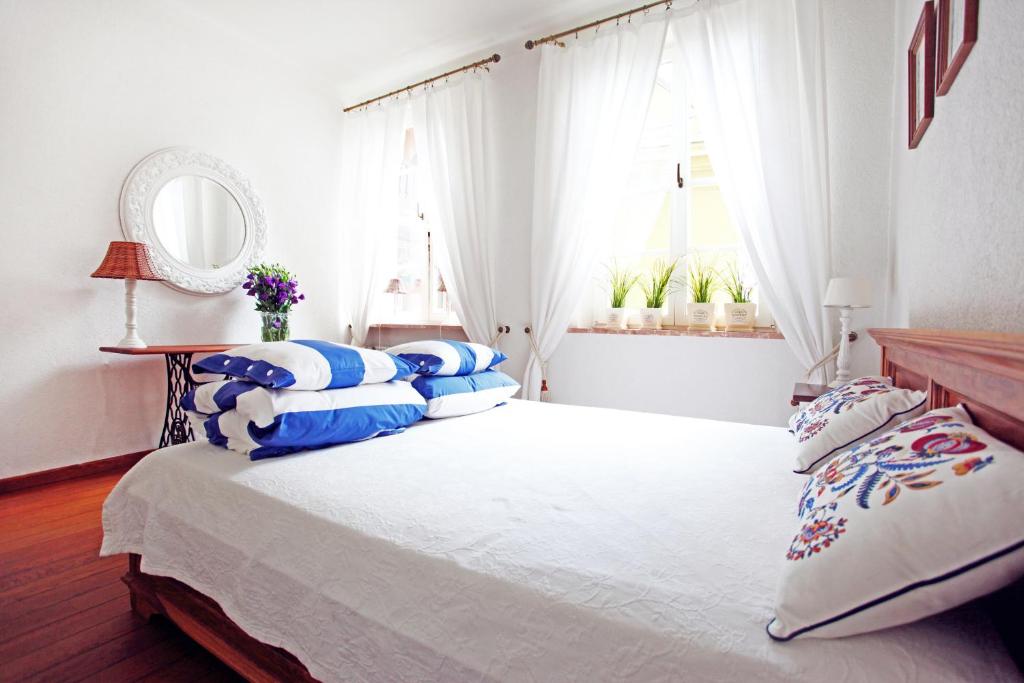 a bedroom with a large bed with blue and white pillows at Castle Square Apartment in Warsaw