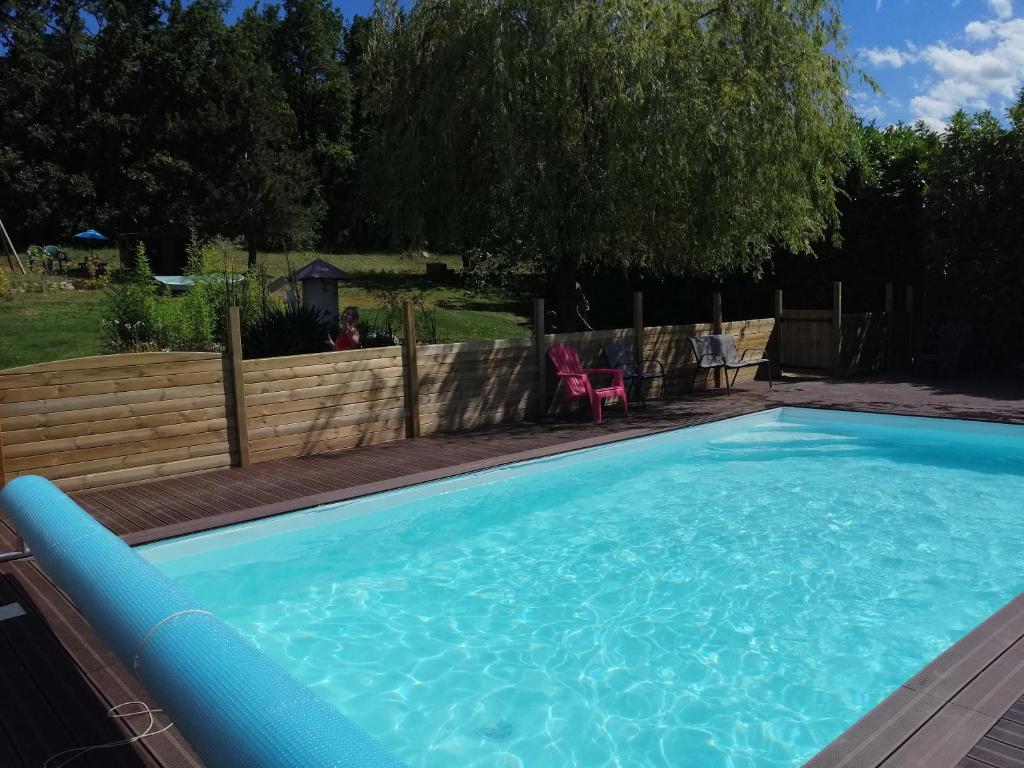 uma grande piscina azul num quintal em patrice et chrstel Cabane en bois em Chatuzange-le-Goubet