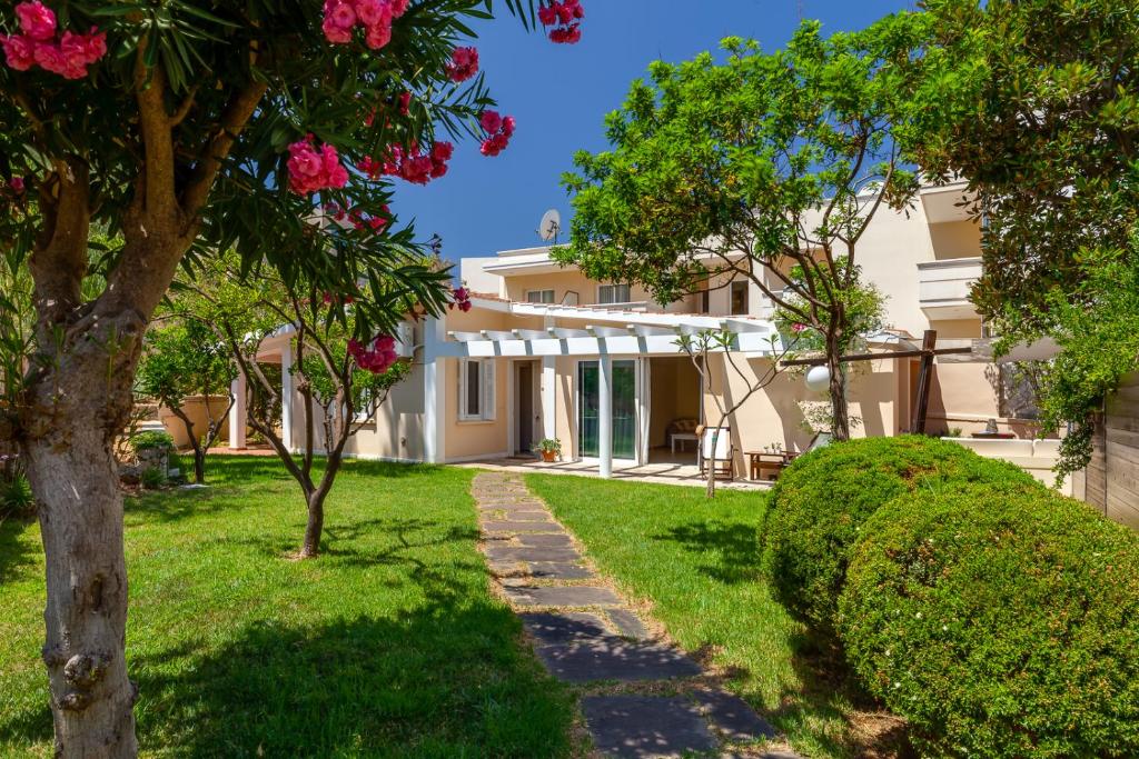 a villa with a garden and a pathway at Beach Front House Kalamaki Bungalow in Kato Galatas