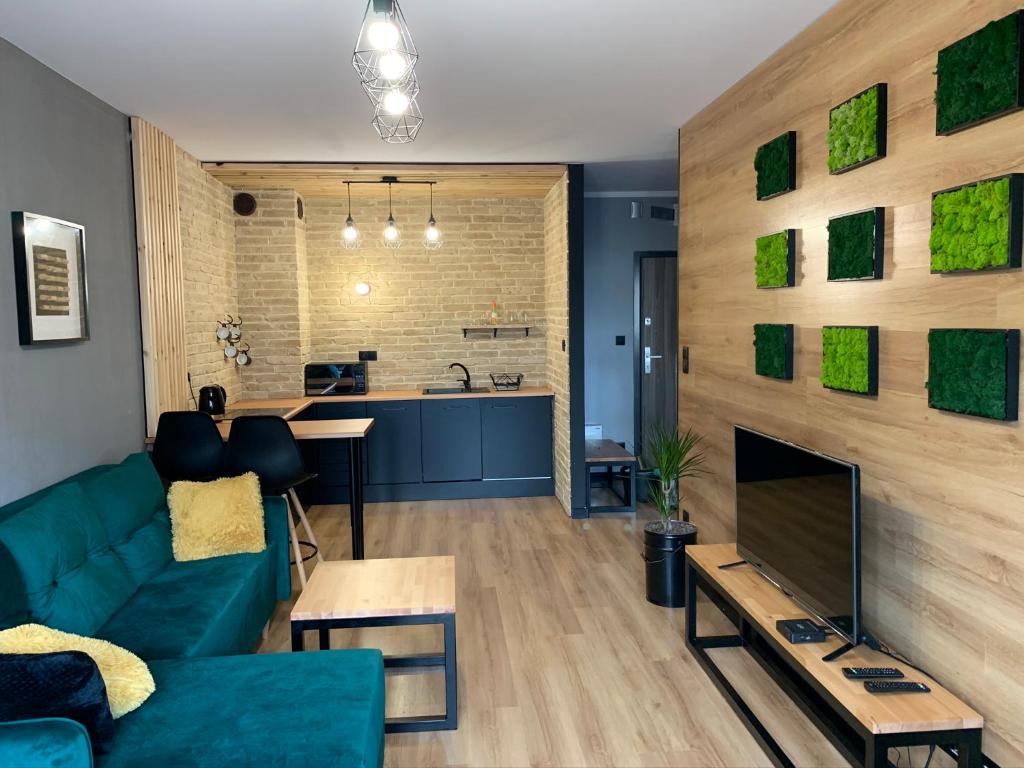 a living room with a couch and a fireplace at Tarnovia Loft Apartment in Tarnowo Podgórne