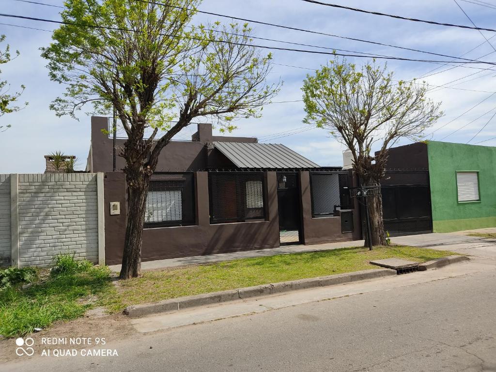 a house on the side of a street with trees at Complejo Berazategui in Villa D. Sobral