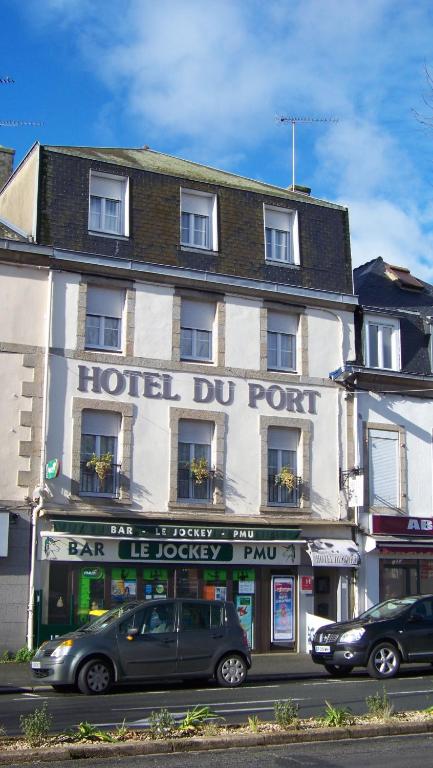 a hotel du port with cars parked in front of it at Hotel Du Port in Concarneau