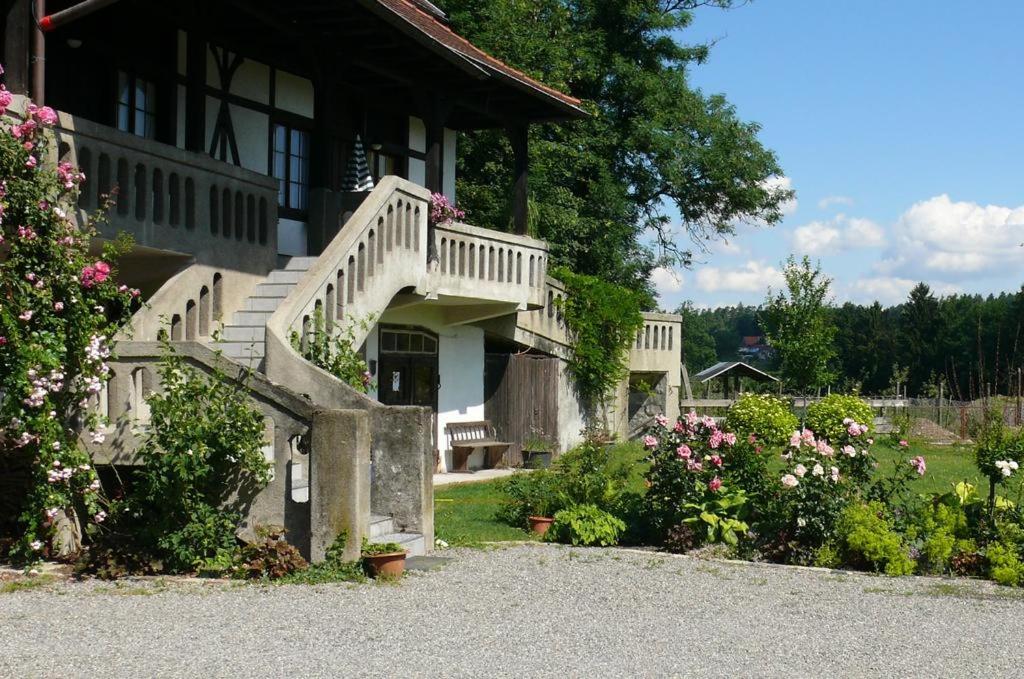 a house with stairs and flowers in front of it at HAUS WALD und SEE - WASSERBURG in Wasserburg