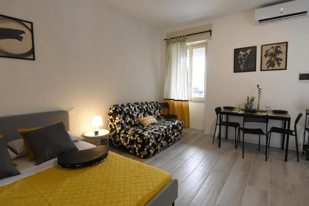 a living room with a bed and a couch and a table at La Casa di Oreno in Vimercate