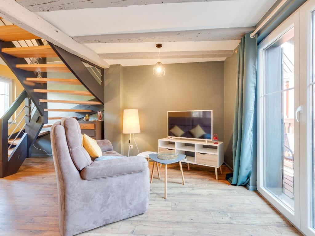 a living room with a couch and a tv at Stunning Apartment in heart of Dambach La Ville in Dambach-la-Ville