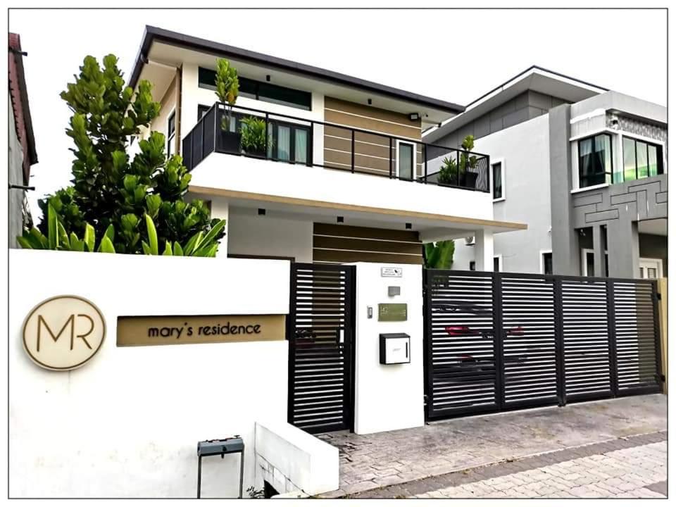 a modern house with a black and white fence at Mary's Residence Ipoh in Ipoh