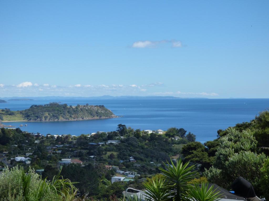 a view of the ocean from the top of a hill at Sea La Vie - Waiheke Island Luxury Accommodation in Onetangi