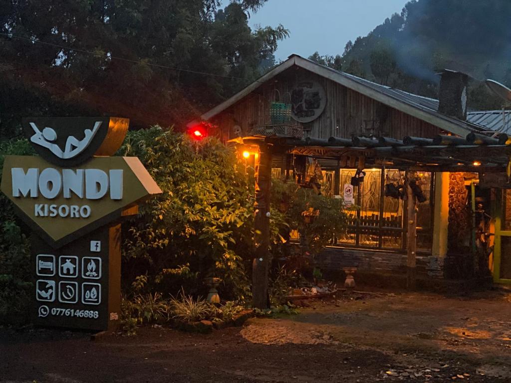 a sign in front of a building with a sign at Mondi Lodge Kisoro in Kisoro