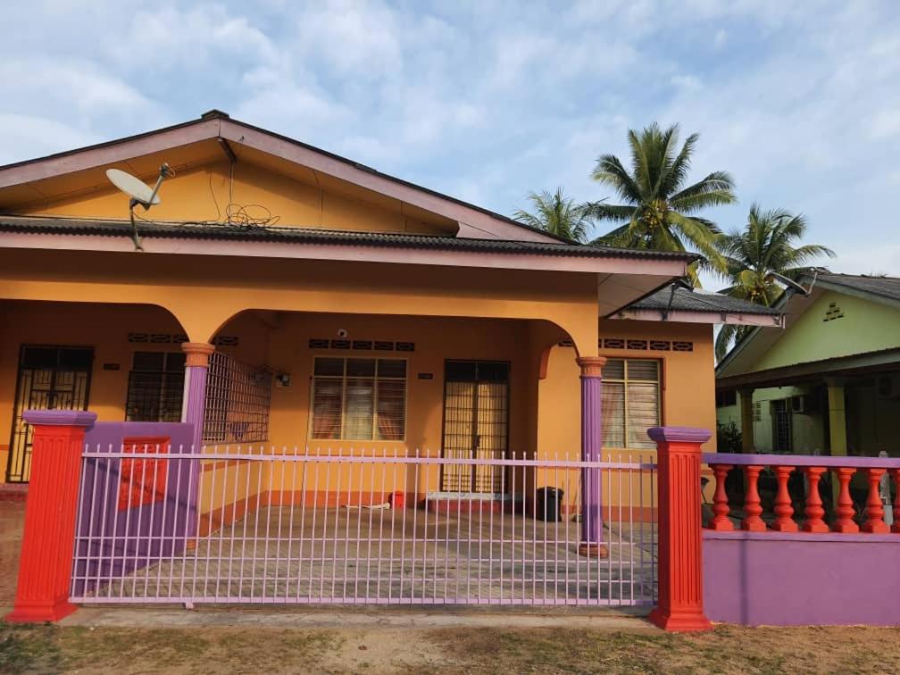 a colorful house with a fence in front of it at Homestay Bonda in Kampong Amir
