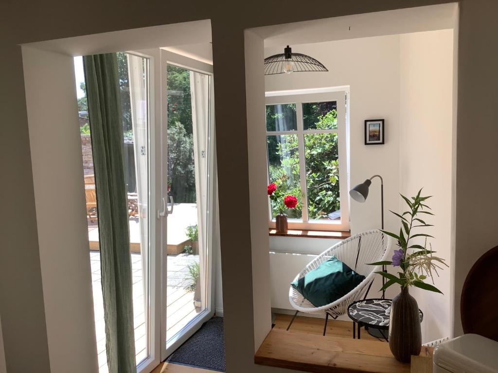 a living room with a chair and a window at Haus Schönkamp in Lübeck