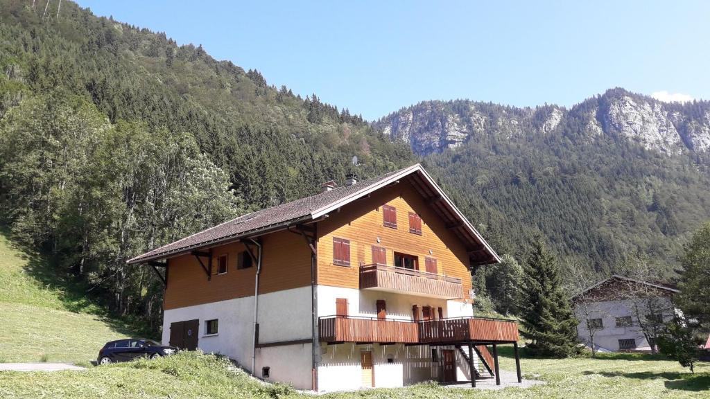 a wooden house with a balcony on a mountain at Grand Bornand-La Clusaz in Entremont