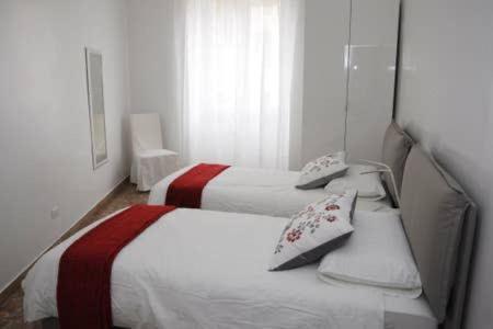 A bed or beds in a room at Al Portico d'Ottavia