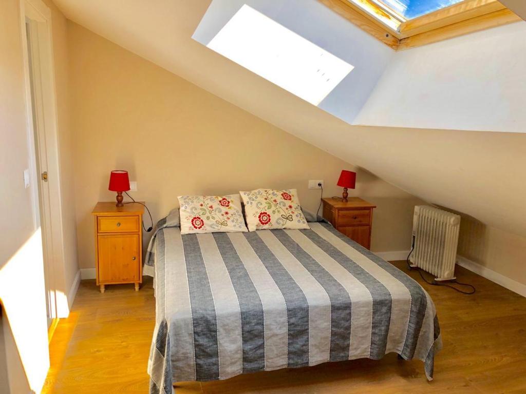 a attic bedroom with a bed and a skylight at PROBER-CHAMOIX 68 in Encamp