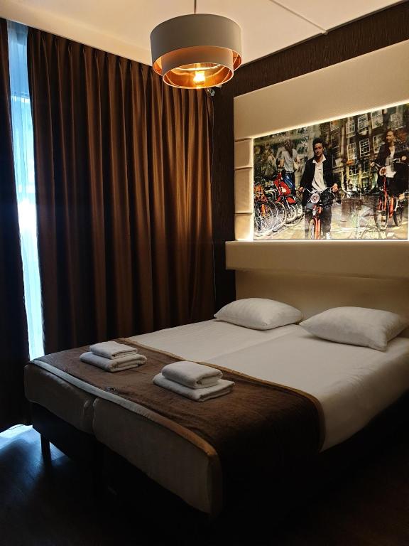 Postel nebo postele na pokoji v ubytování Hotel Mosaic City Centre
