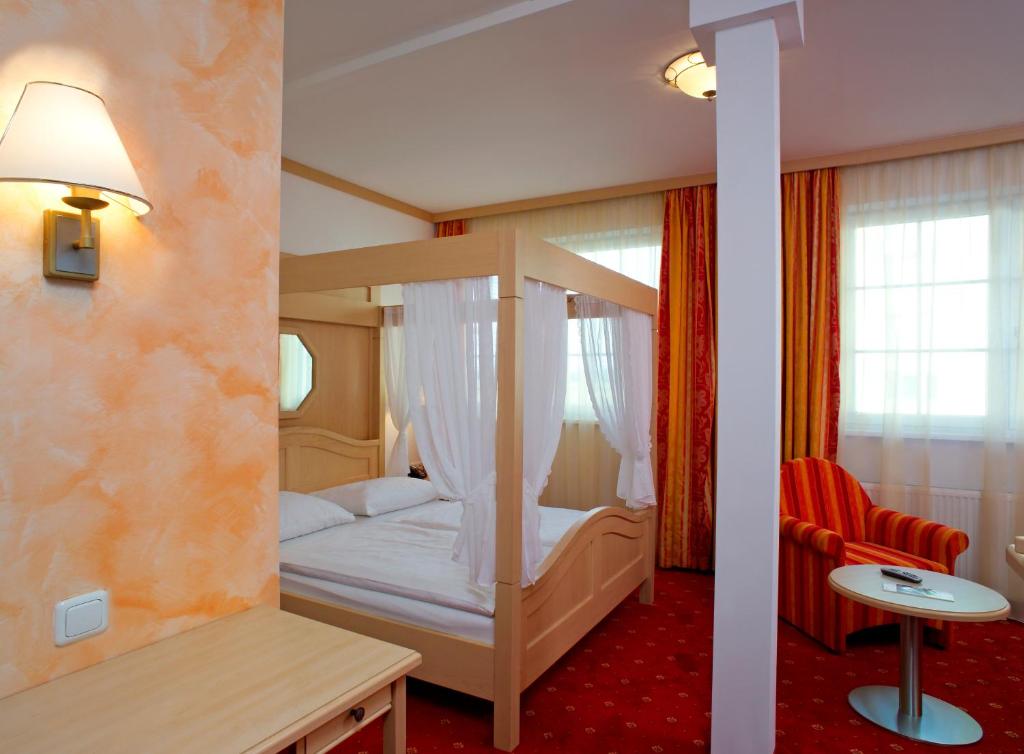 a bedroom with a bunk bed and a red carpet at Hotel Restaurant Wallner I contactless check-in in Sankt Valentin