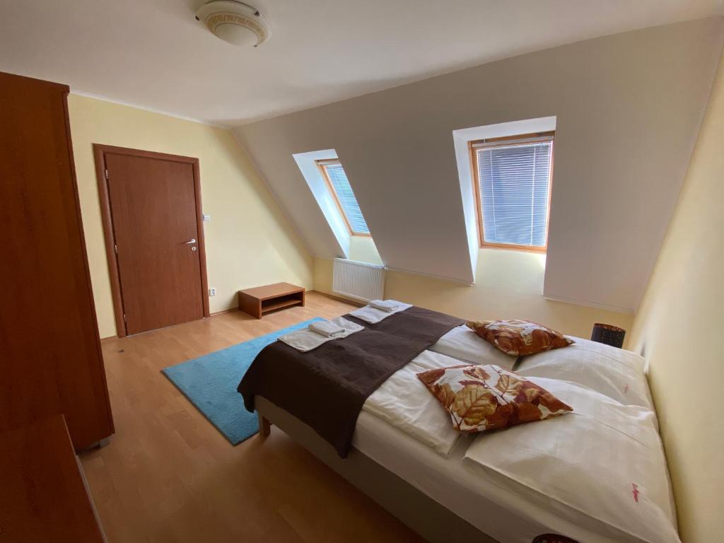 a bedroom with a bed with two pillows on it at Penzion Le Monde in Bardejov