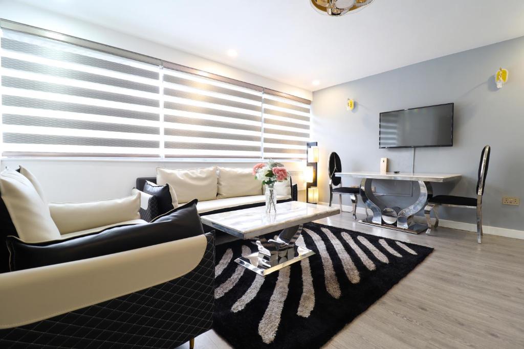 a living room with a couch and a table at Queen Stay Apartments in Sheffield