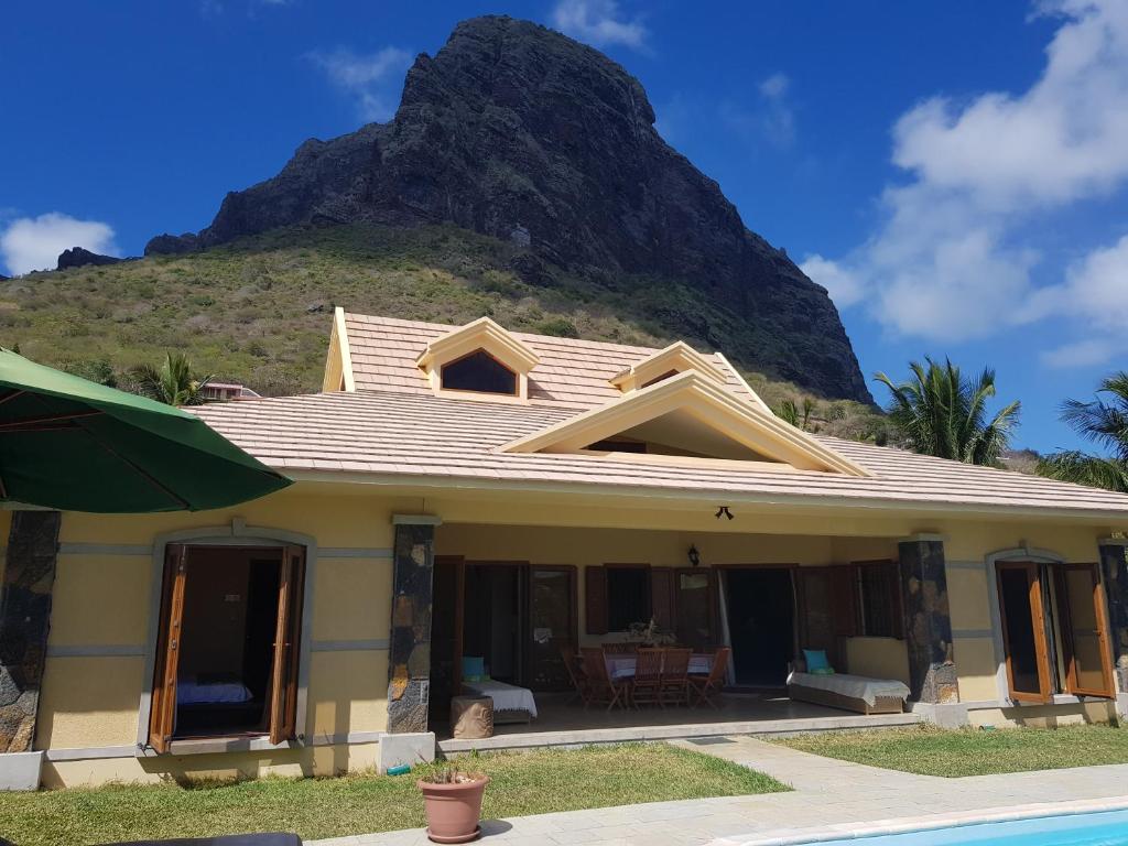 a house with a mountain in the background at La Villa Marie Joana in Le Morne