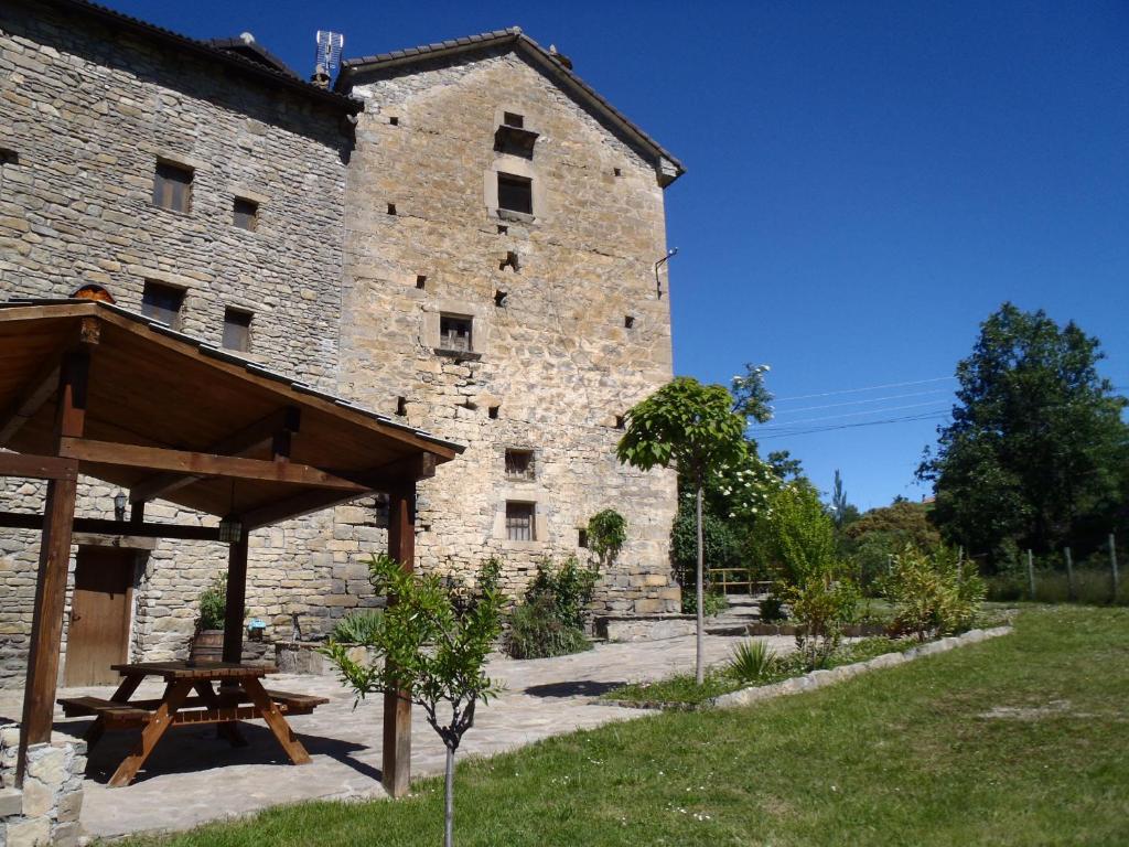 a stone building with a picnic table in front of it at Casa Bestregui in Guaso
