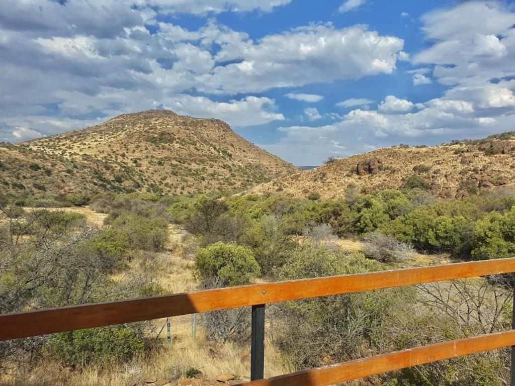 a view of a mountain from a fence at Vrede Fountain House Farm Stay in Graaff-Reinet